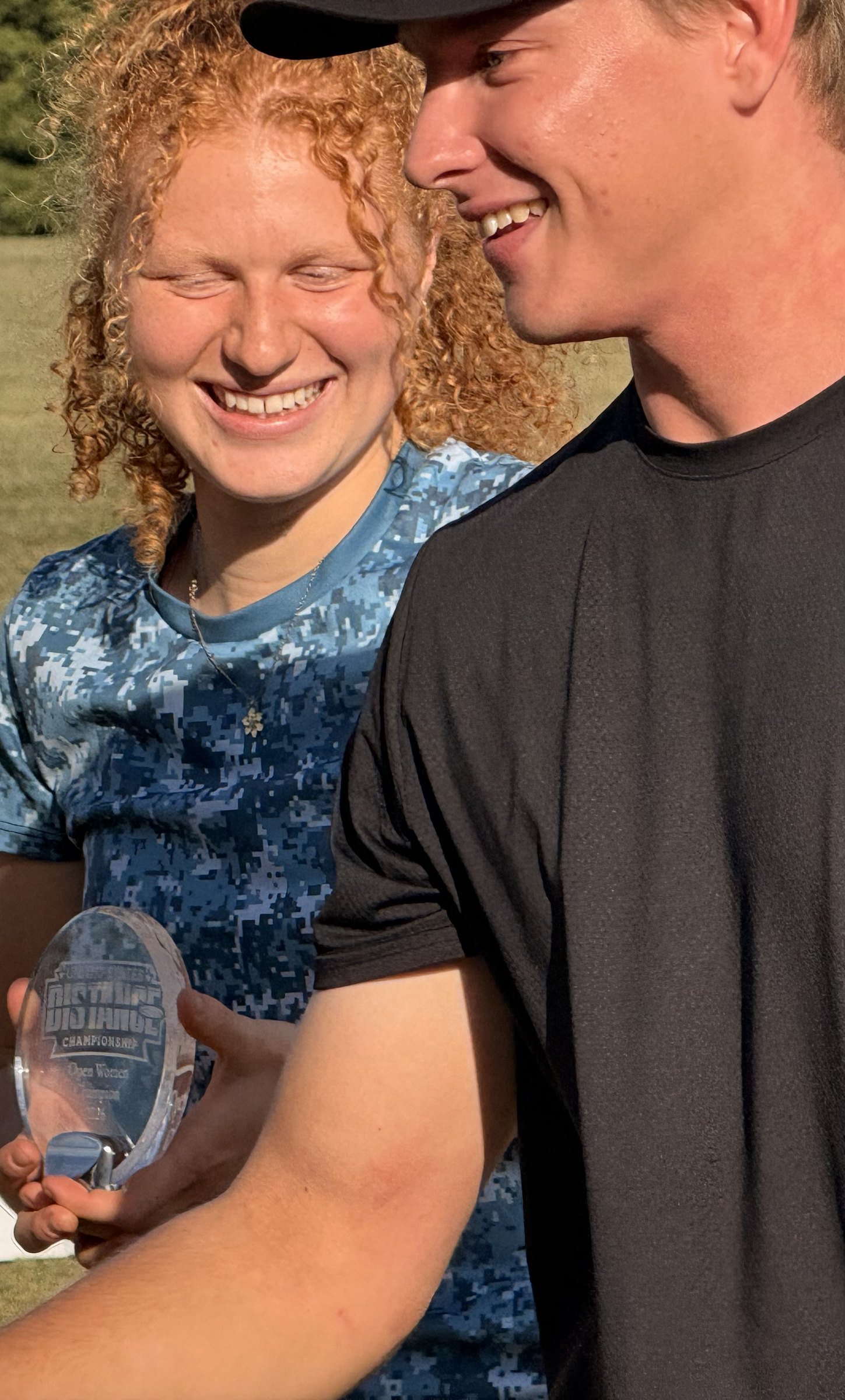 Two competitors smiling with a trophy at the 2026 US Disc Golf Distance Championship.