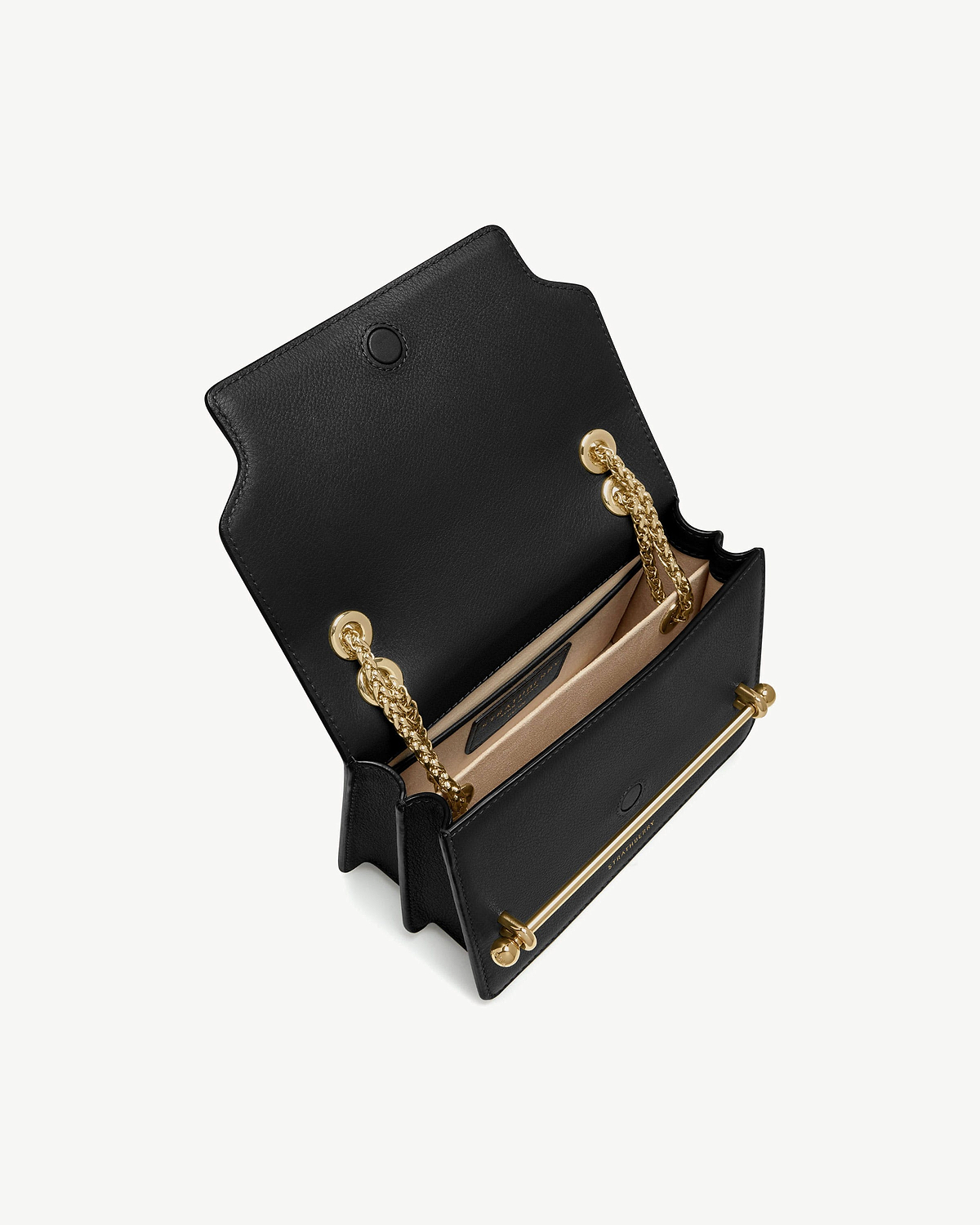 Black East/West mini bag open, showing gold chain strap and interior card slot.