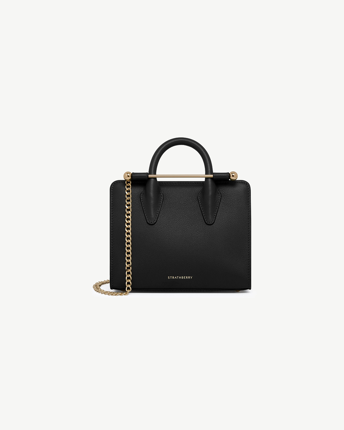 Strathberry black nano tote with top handles and gold chain strap.