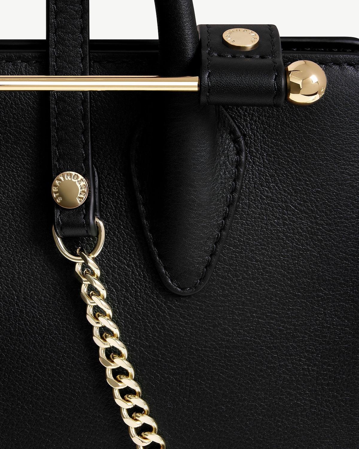 Black Strathberry Nano Tote leather panel with gold bar, stud and chain strap.
