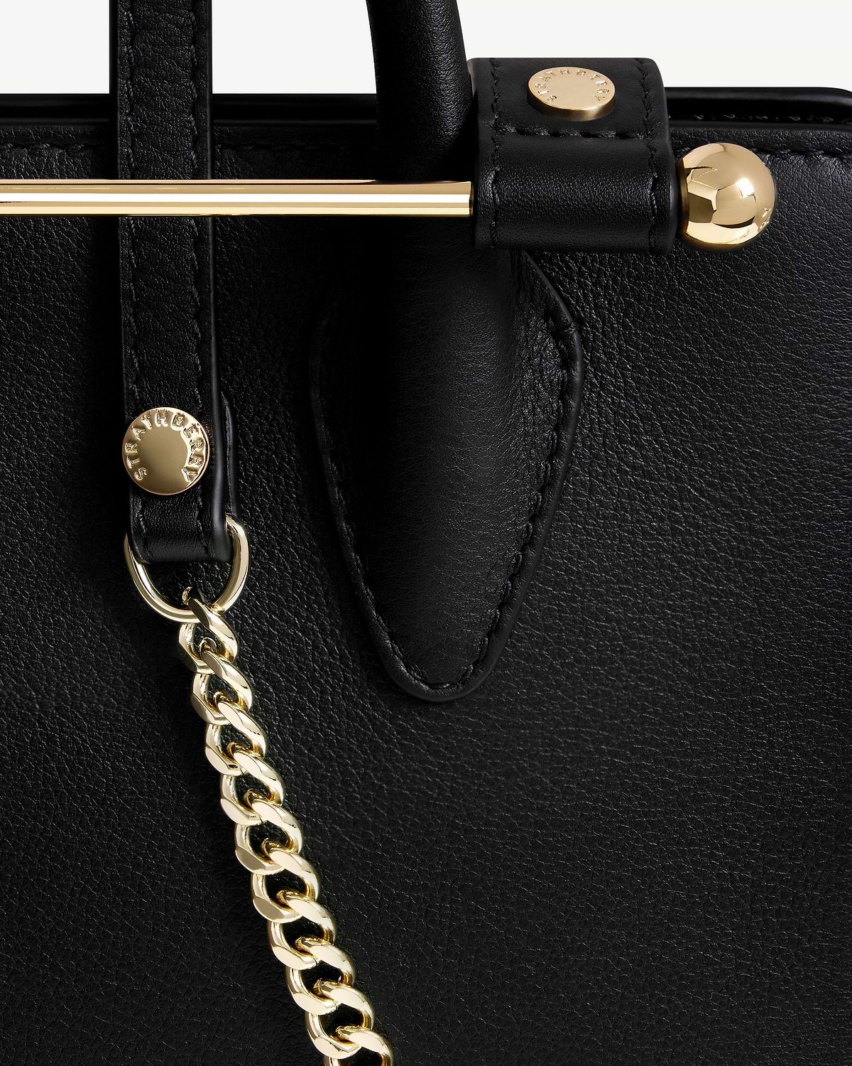 Black Strathberry Nano Tote leather panel with gold bar, stud and chain strap.