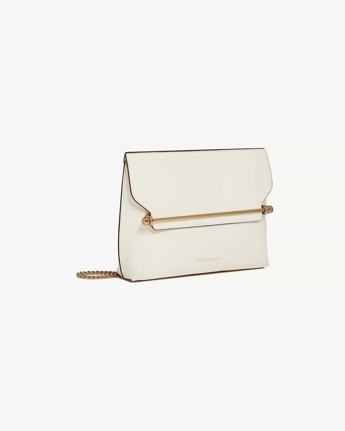 Vanilla Stylist bag with gold bar detail, chain strap and Strathberry logo.