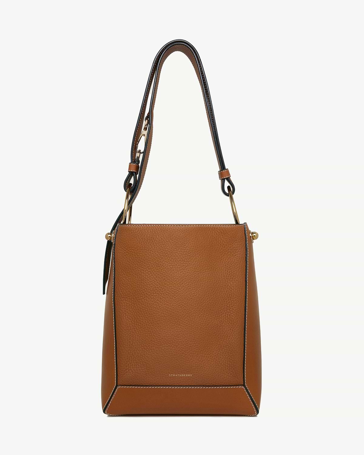 Tan leather bucket bag with vanilla contrast stitching and gold hardware, Strathberry logo.