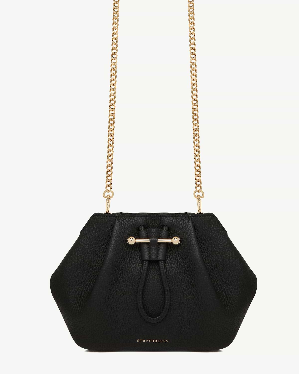 Gold short chain strap attached to Strathberry black pebbled leather crossbody bag.
