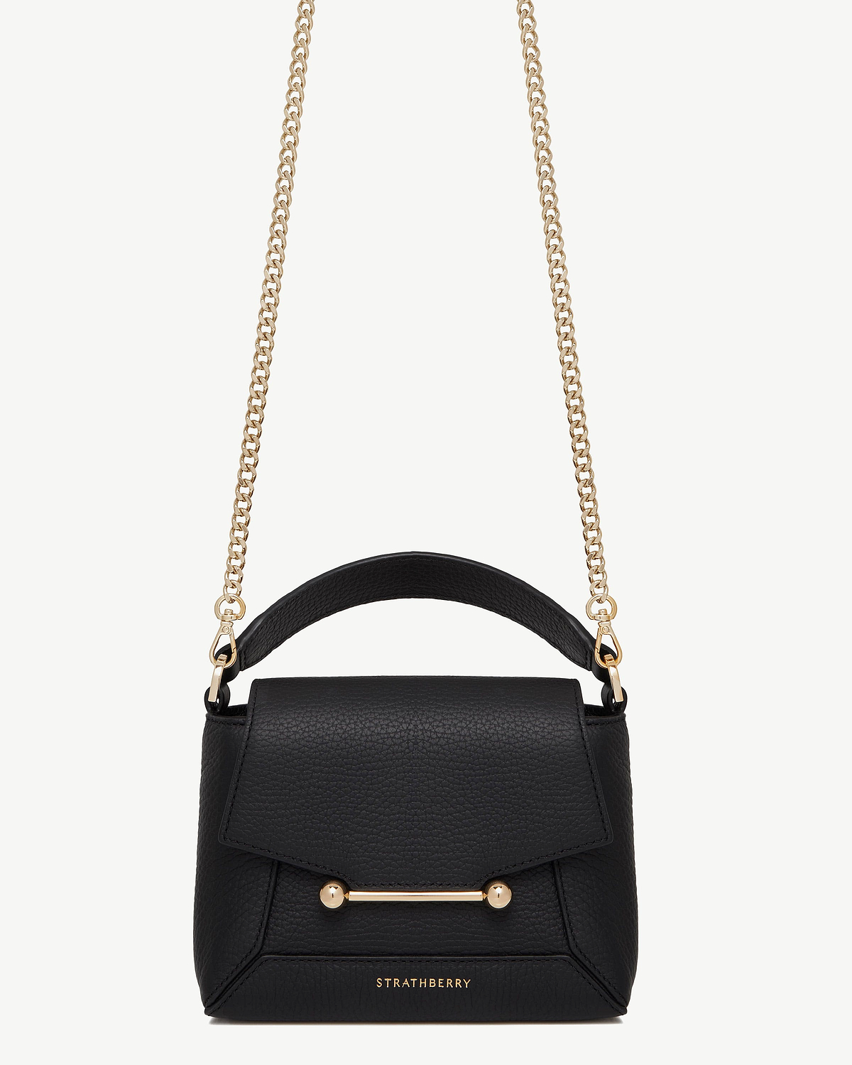 Black Strathberry bag with short gold chain strap, leather top handle, bar closure.