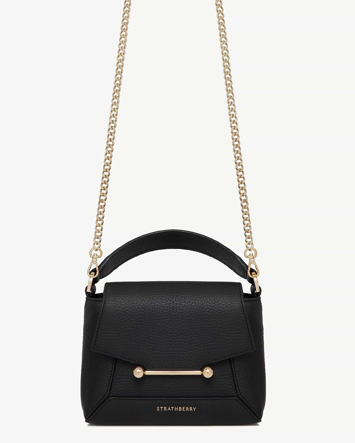 Black Strathberry bag with short gold chain strap, leather top handle, bar closure.