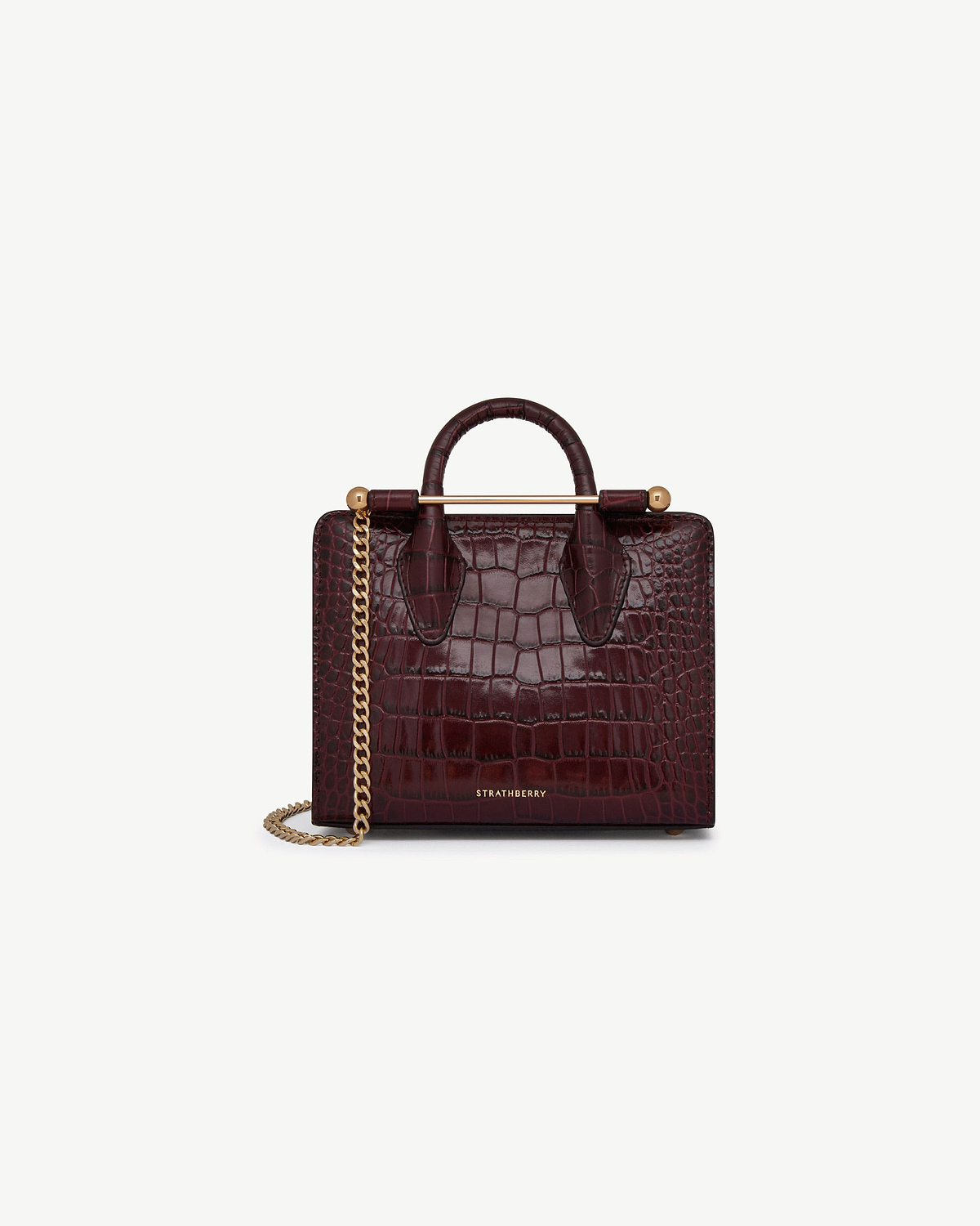Strathberry croc-embossed nano tote in burgundy with gold bar and chain strap.