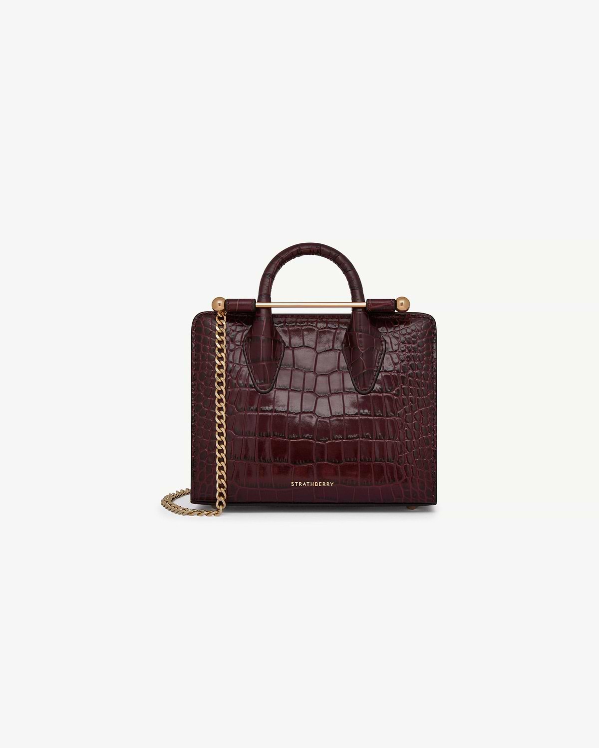 Strathberry croc-embossed nano tote in burgundy with gold bar and chain strap.