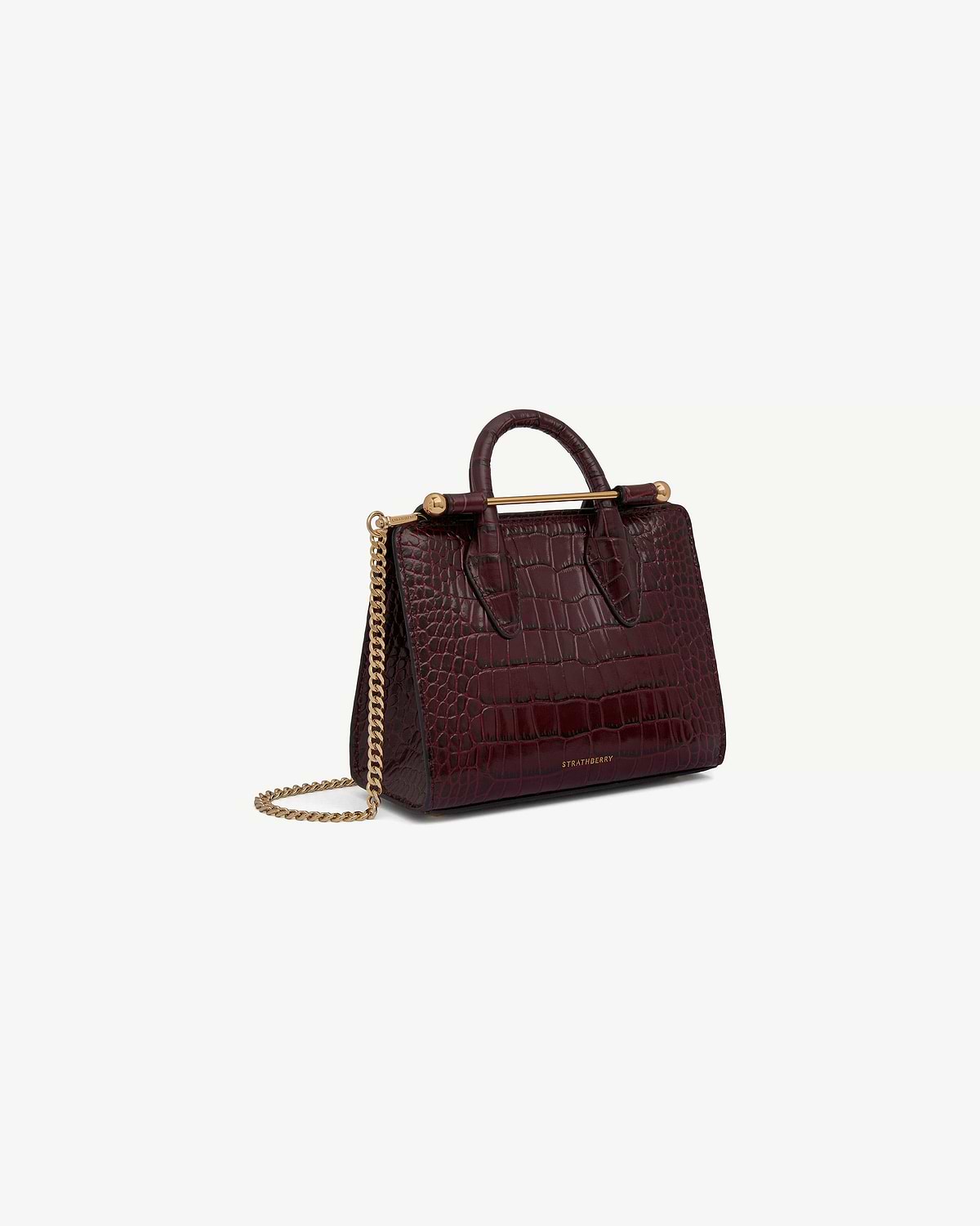 Burgundy croc-embossed nano tote with top handle, gold bar, chain strap, Strathberry.