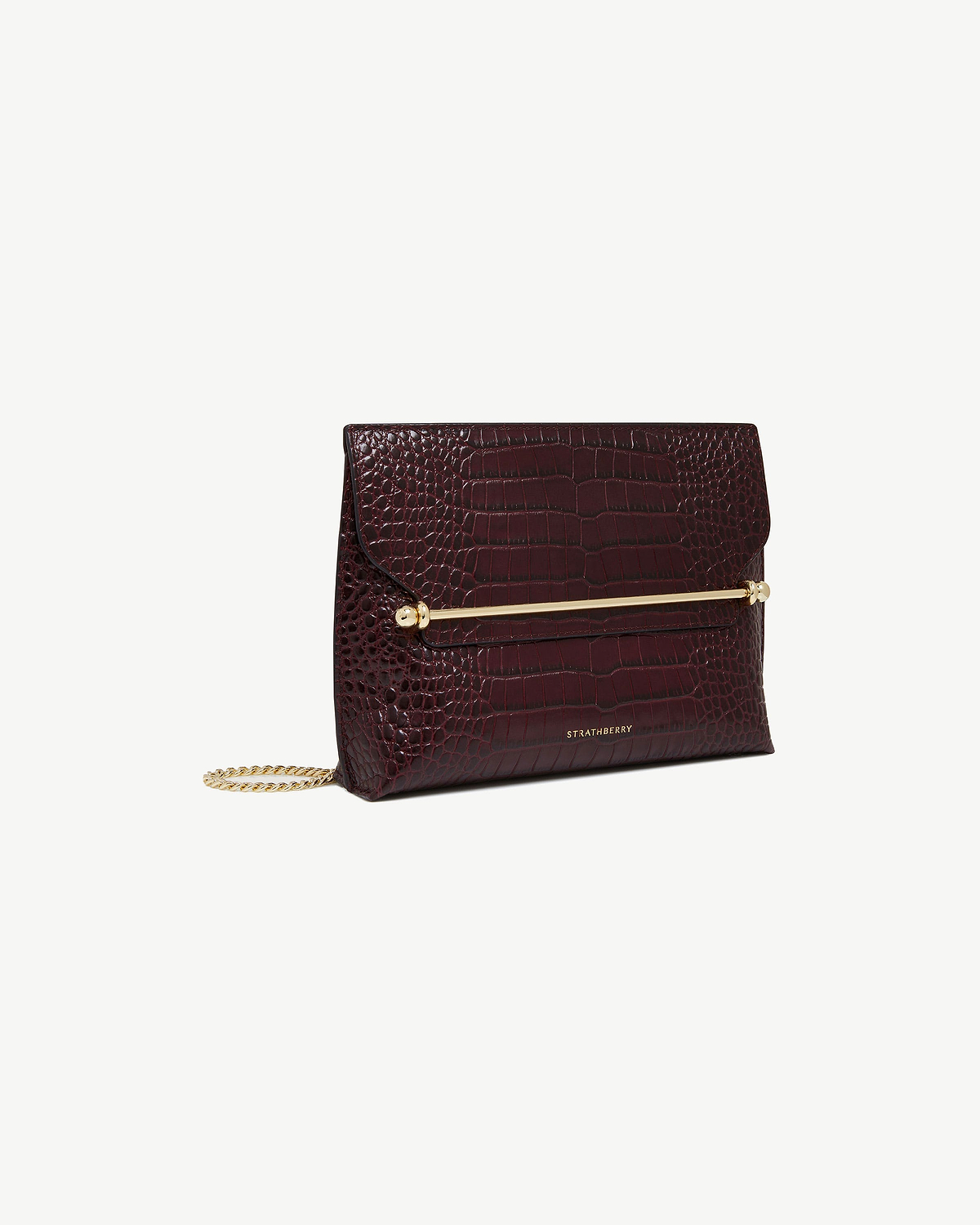 Burgundy croc-embossed Stylist bag with gold bar and chain, Strathberry logo.