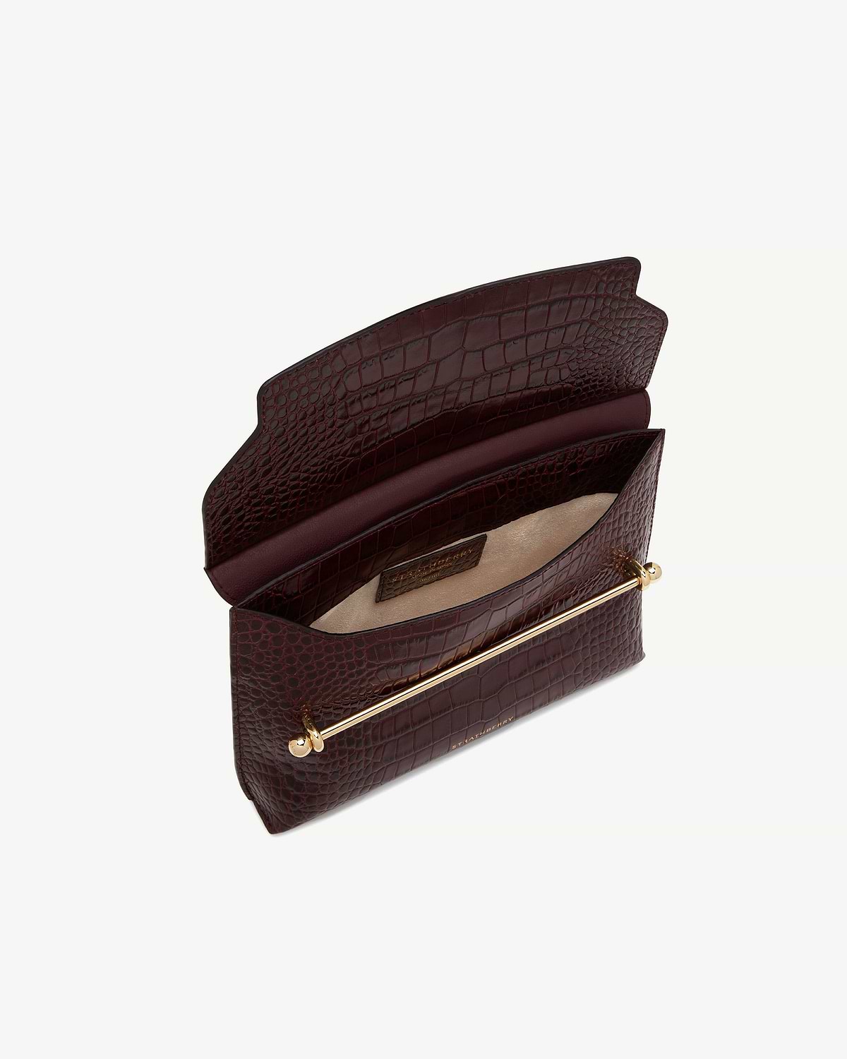 Open burgundy croc-embossed leather bag with gold bar detail and beige interior