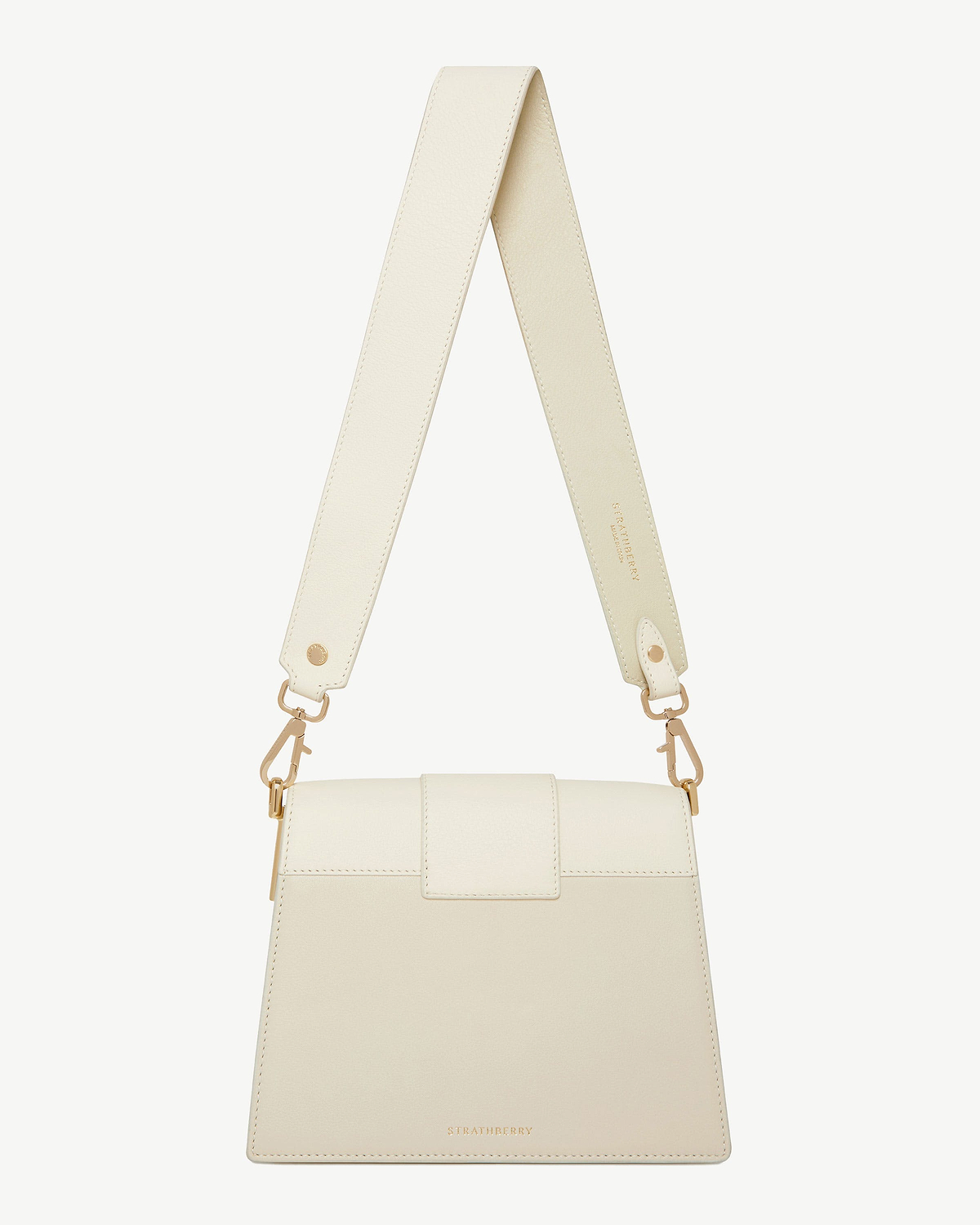 Box Crescent bag in vanilla and diamond colours with visible Strathberry logo.