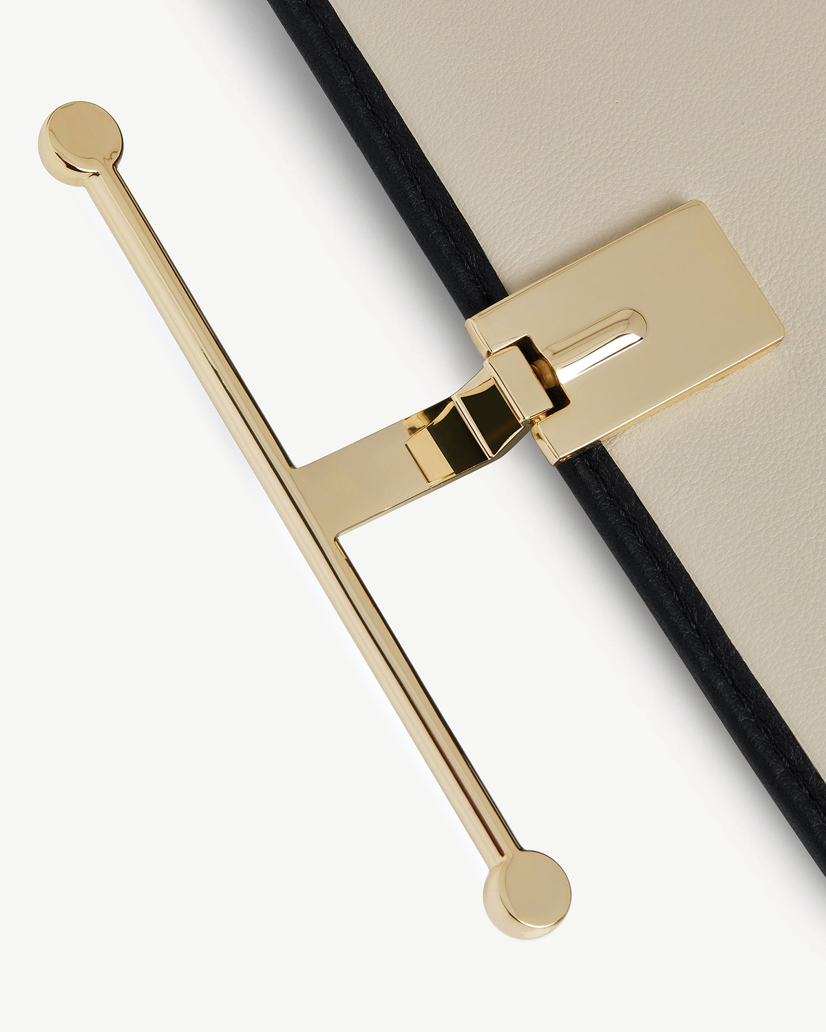 Diamond and black leather large wallet edge showing gold T-bar fastening