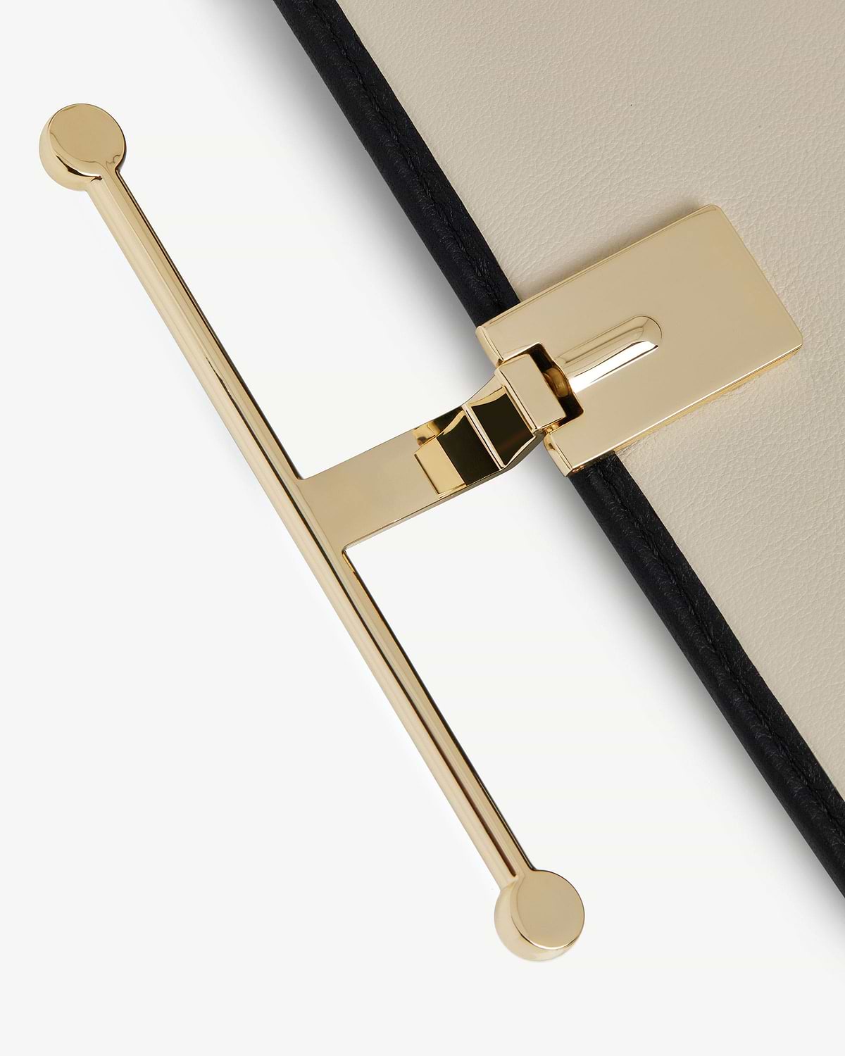 Diamond and black leather large wallet edge showing gold T-bar fastening