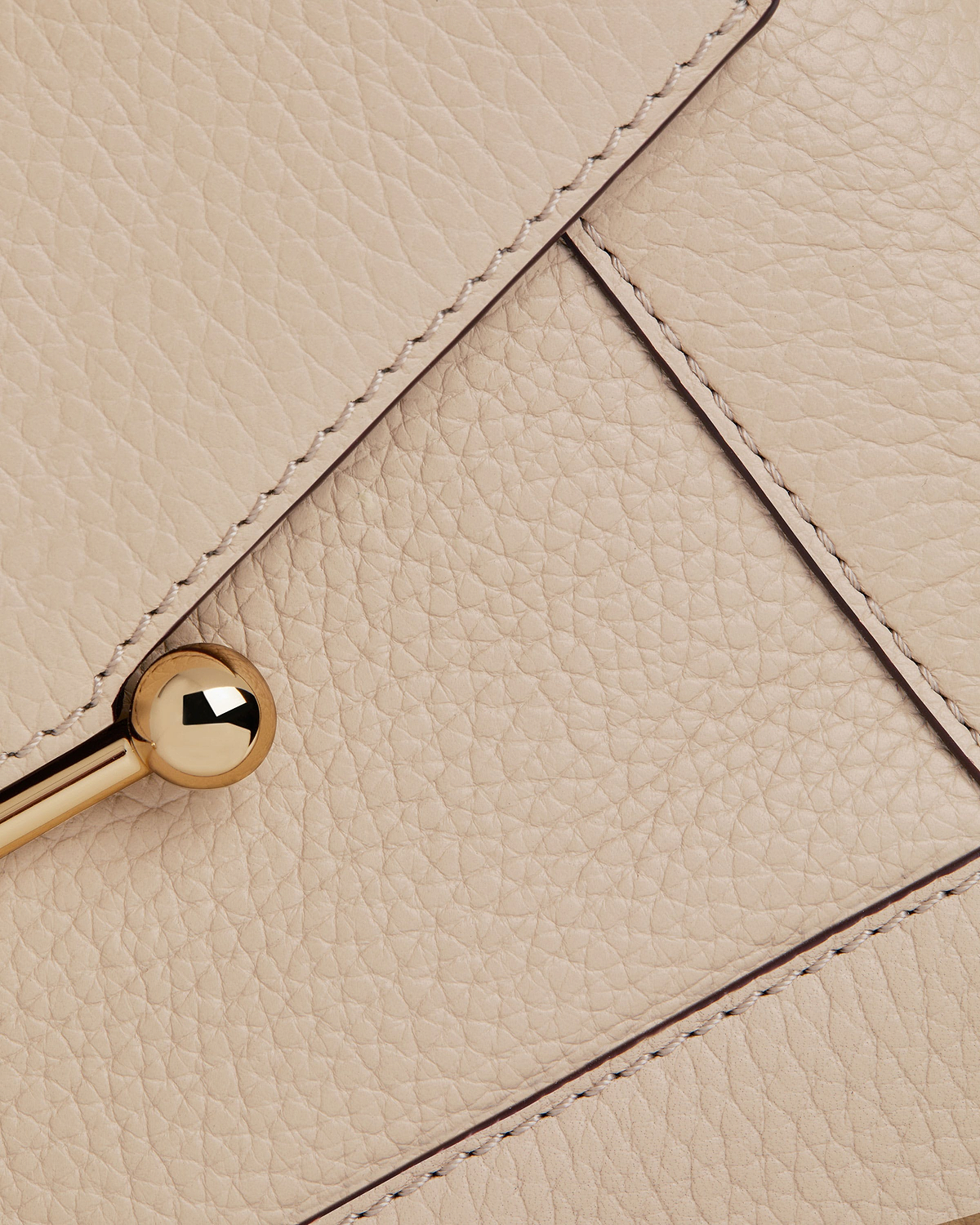 Oat-coloured pebbled leather mosaic bag panel with stitched seams and gold ball clasp.