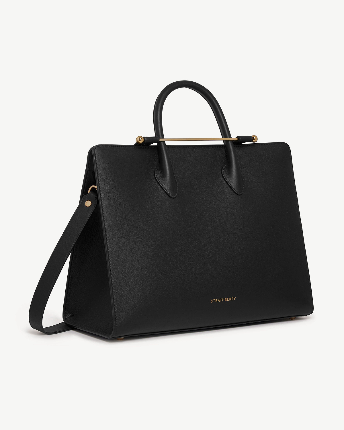 Black Strathberry leather tote with top handles, shoulder strap and gold bar.