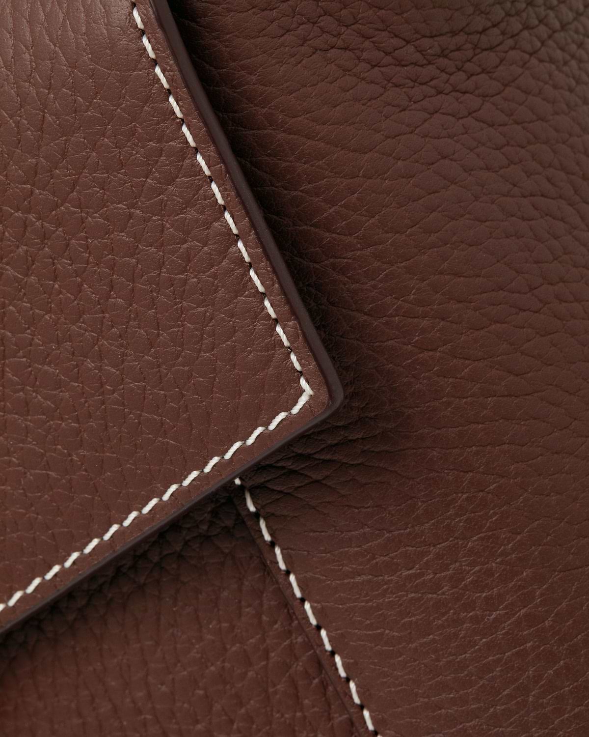 Chocolate pebbled leather with vanilla stitching along a mosaic bag flap.