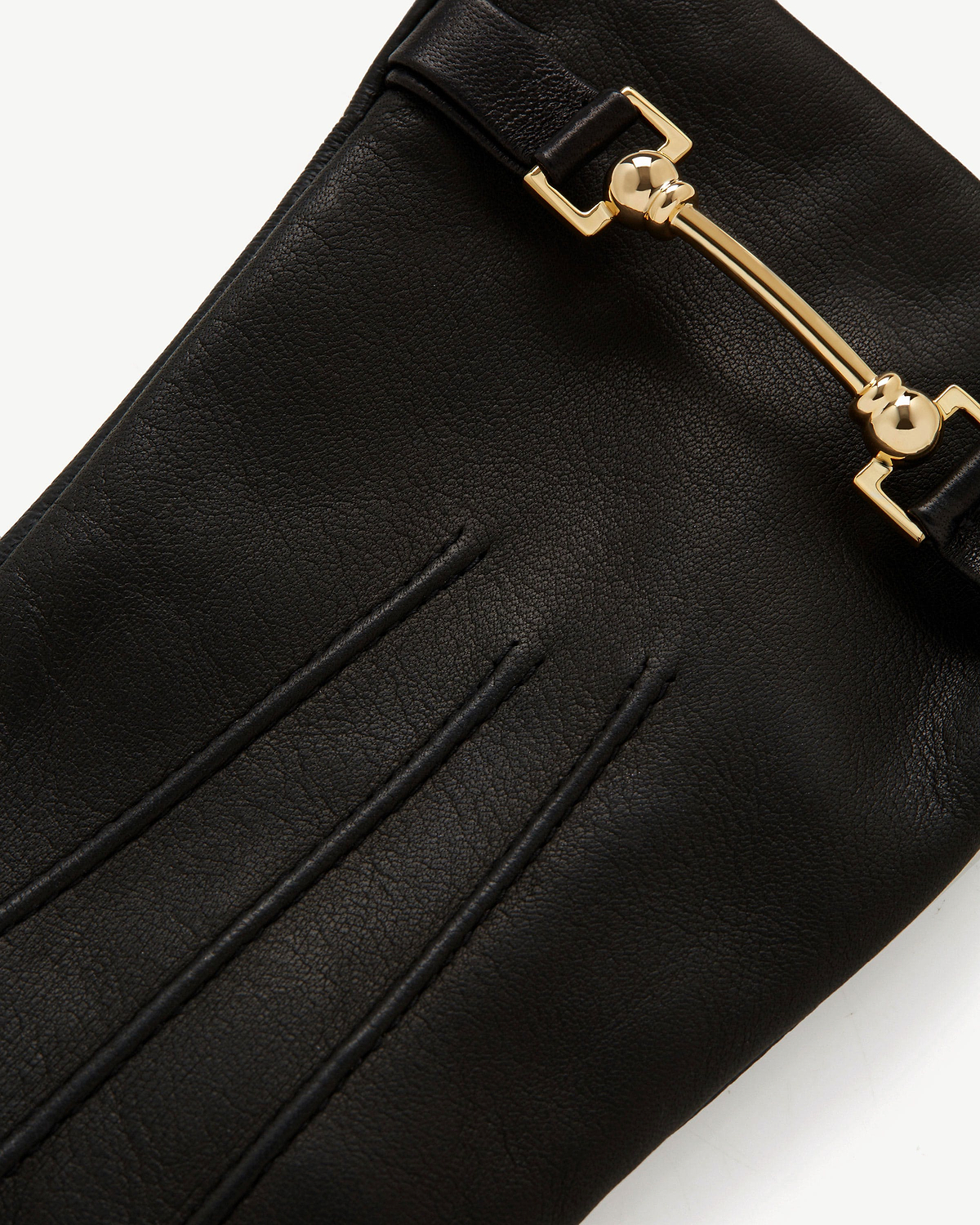 Black leather glove showing gold hardware and three stitched finger lines.