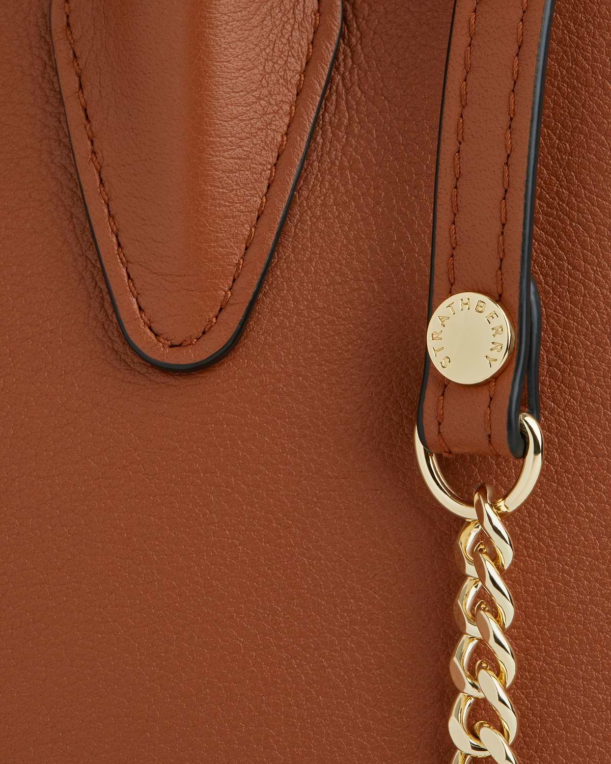 Chestnut mini tote leather detail with gold Strathberry stud and chain.