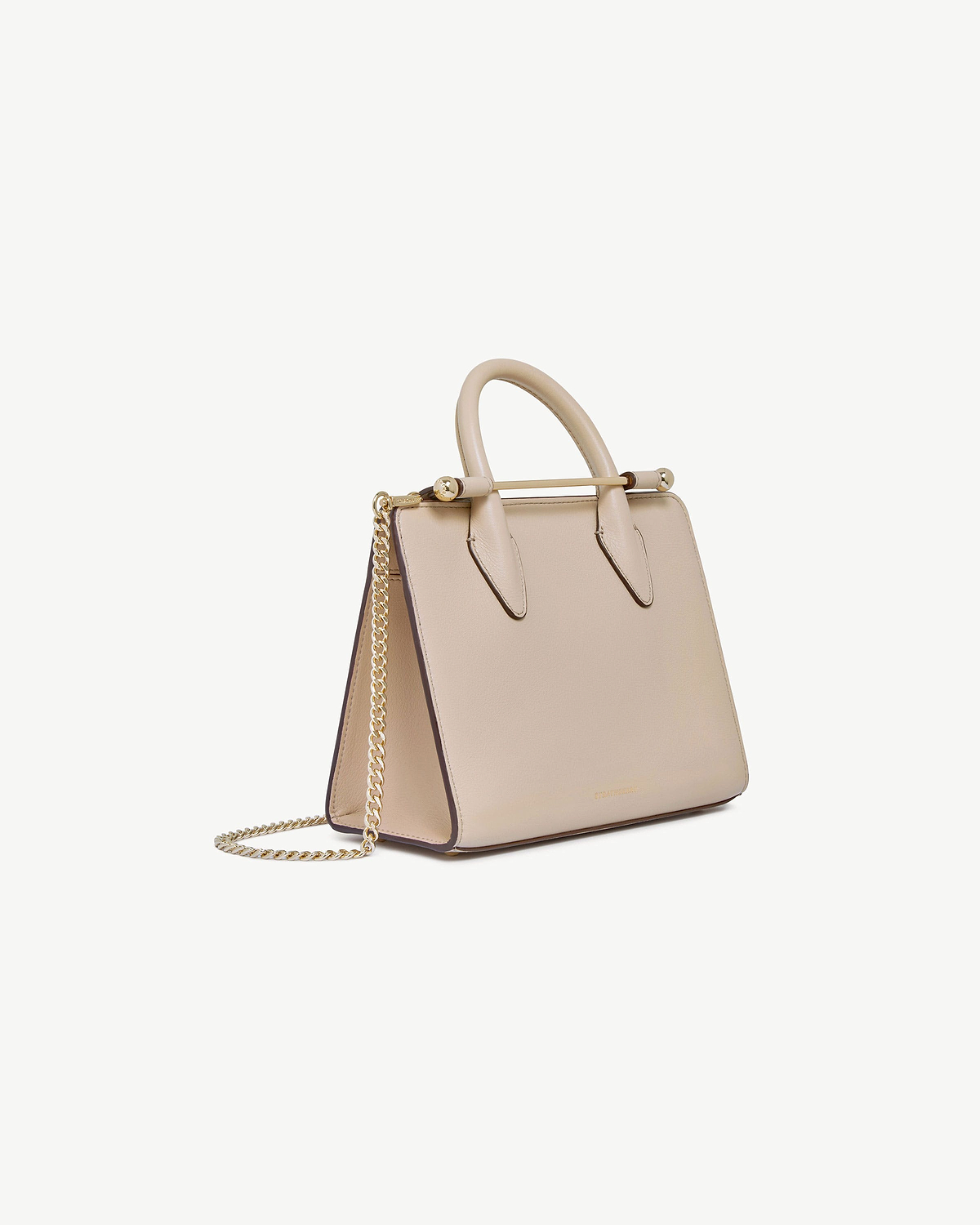 Strathberry oat mini tote with rounded top handles, gold bar detail and chain strap