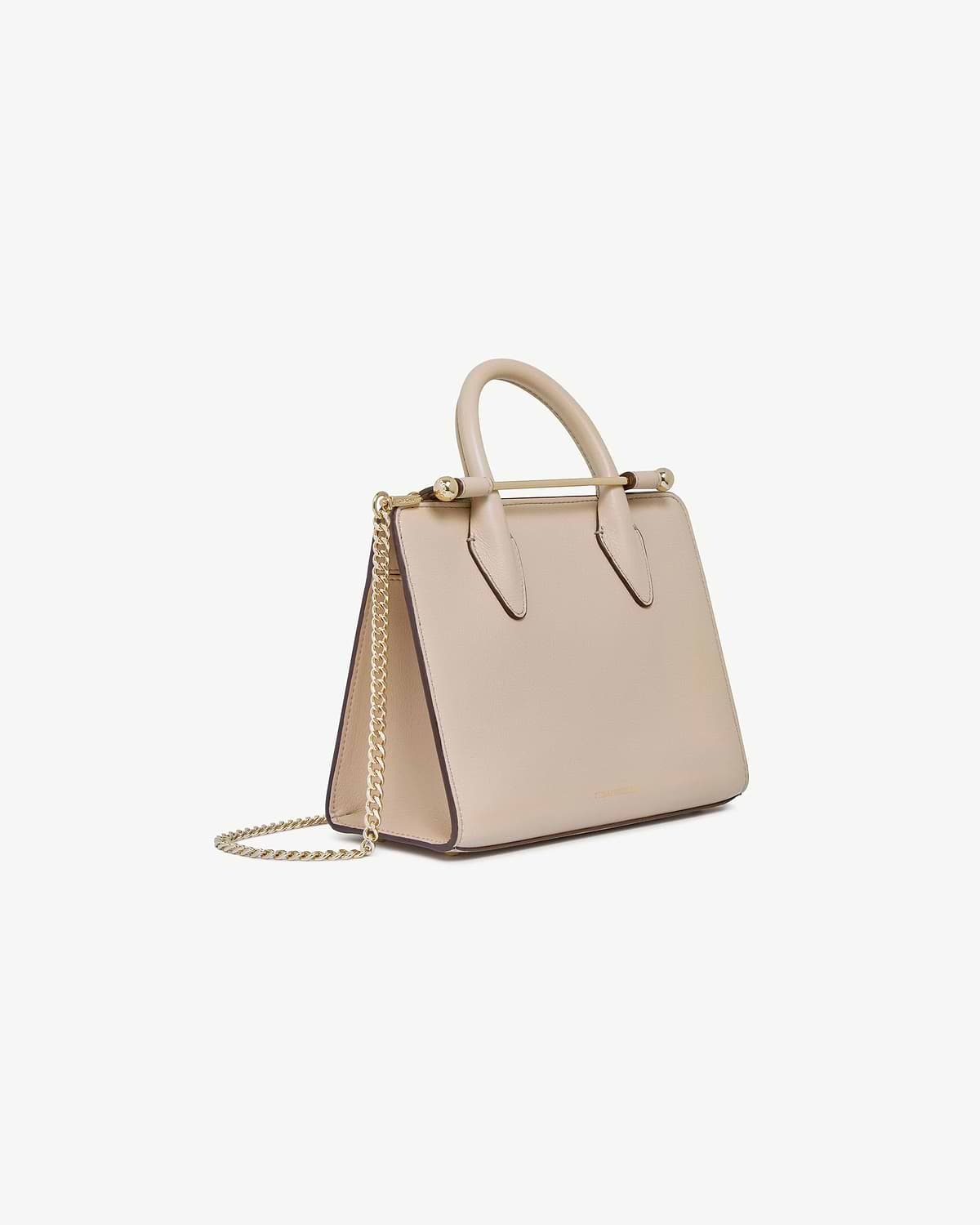 Strathberry oat mini tote with rounded top handles, gold bar detail and chain strap