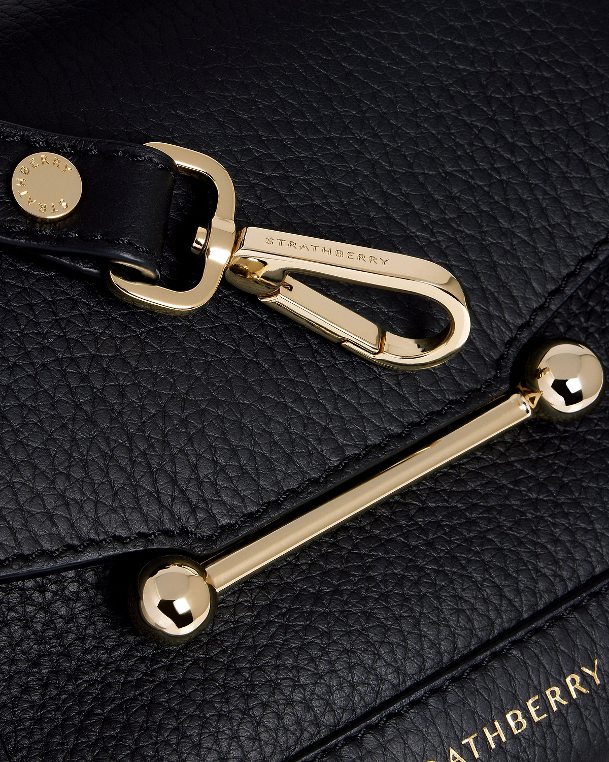 Black pebbled leather with gold Strathberry bar and clasp hardware.