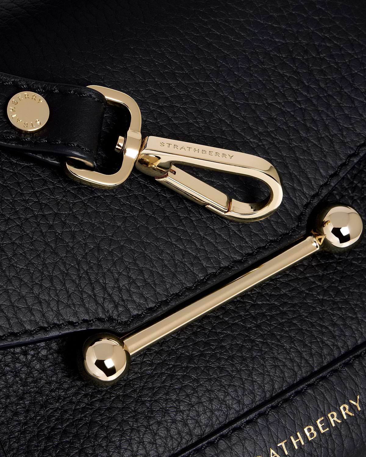Black pebbled leather with gold Strathberry bar and clasp hardware.