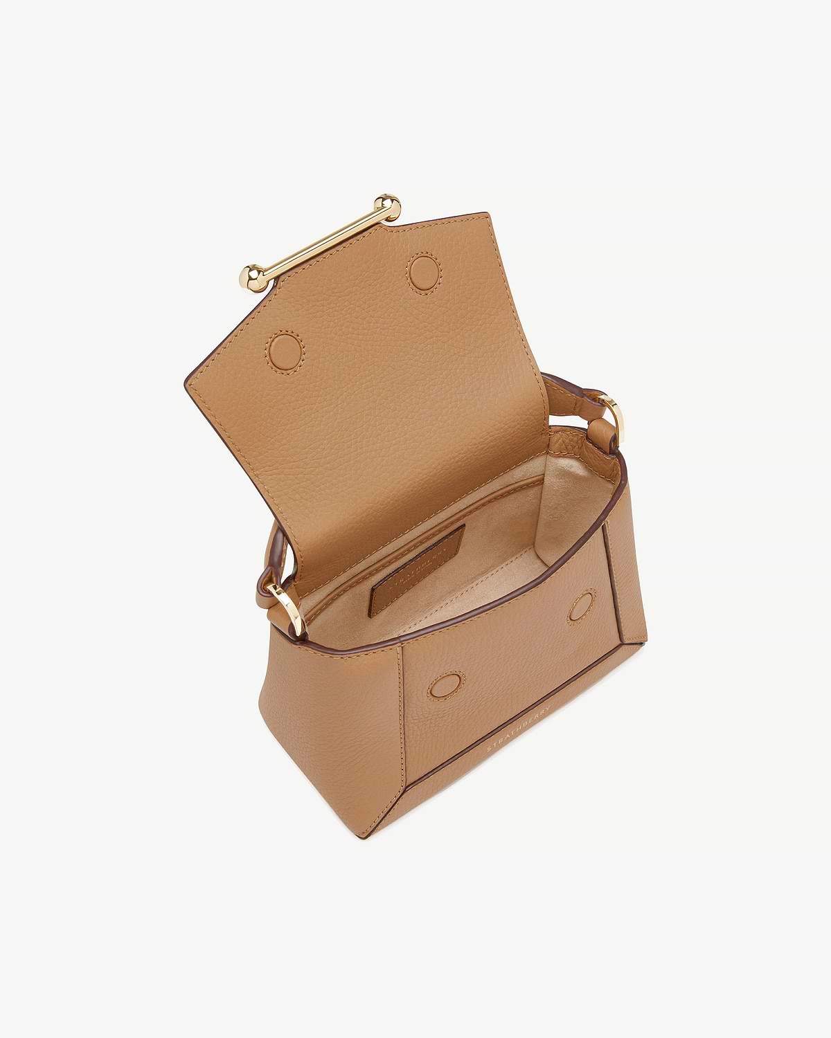 Open Strathberry Mosaic Nano caramel leather bag showing interior and gold bar clasp.
