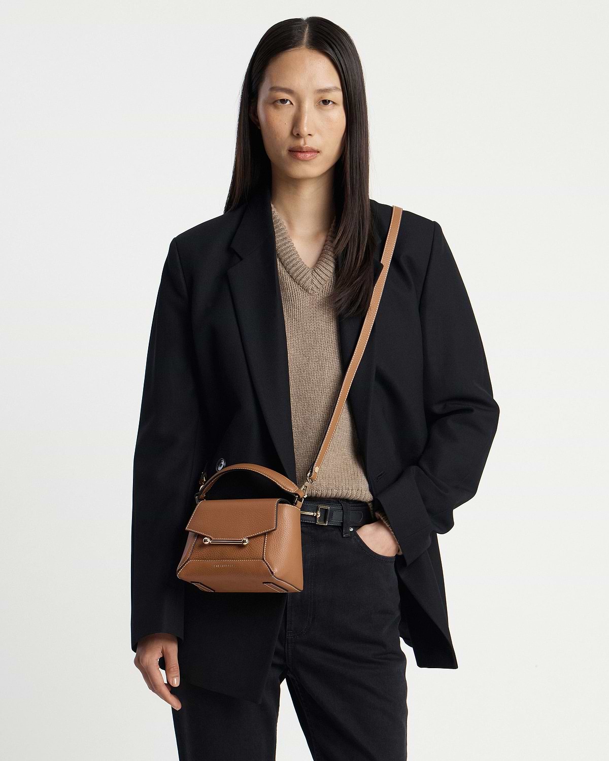 Model wearing tan Mosaic Nano crossbody bag with vanilla stitching and top handle.