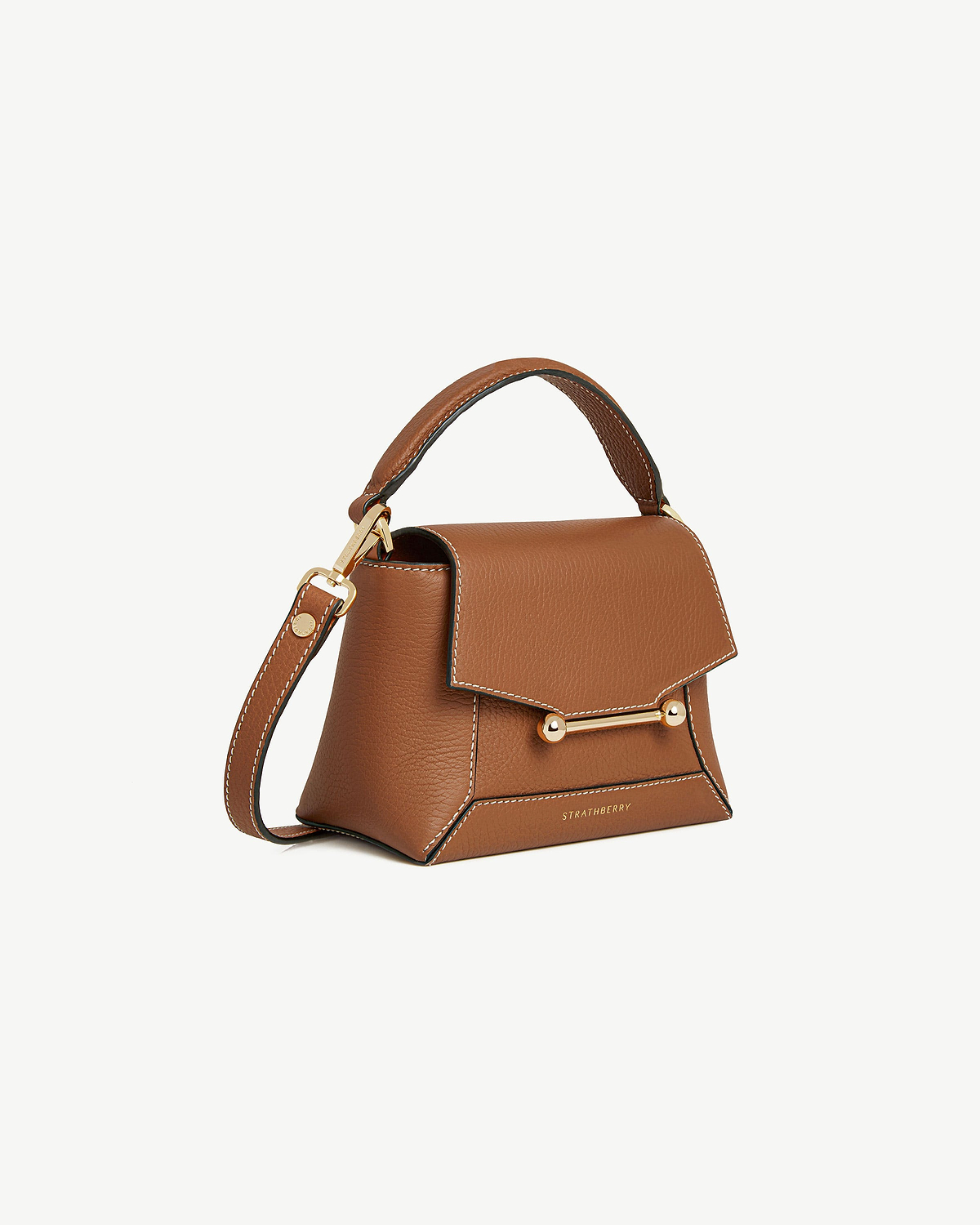 Tan leather Strathberry Mosaic Nano bag with vanilla-coloured stitching, gold bar closure and top handle.