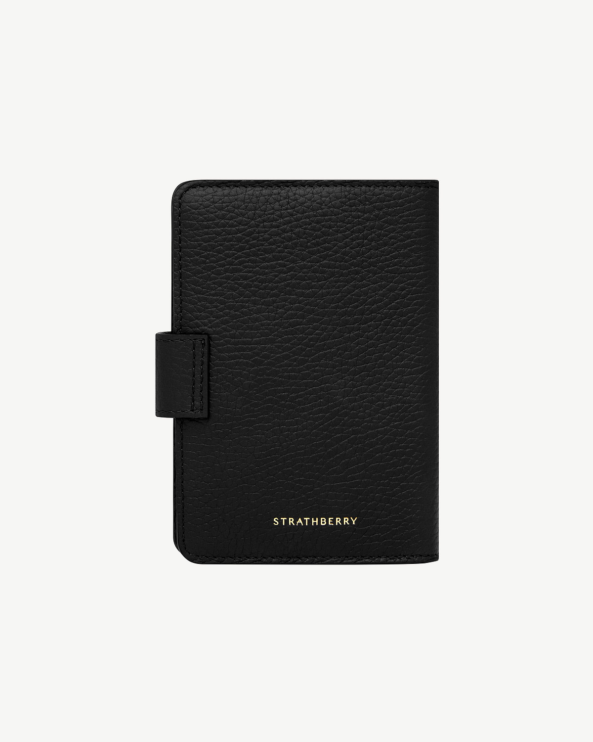 Black textured leather passport holder with tab closure and gold Strathberry logo
