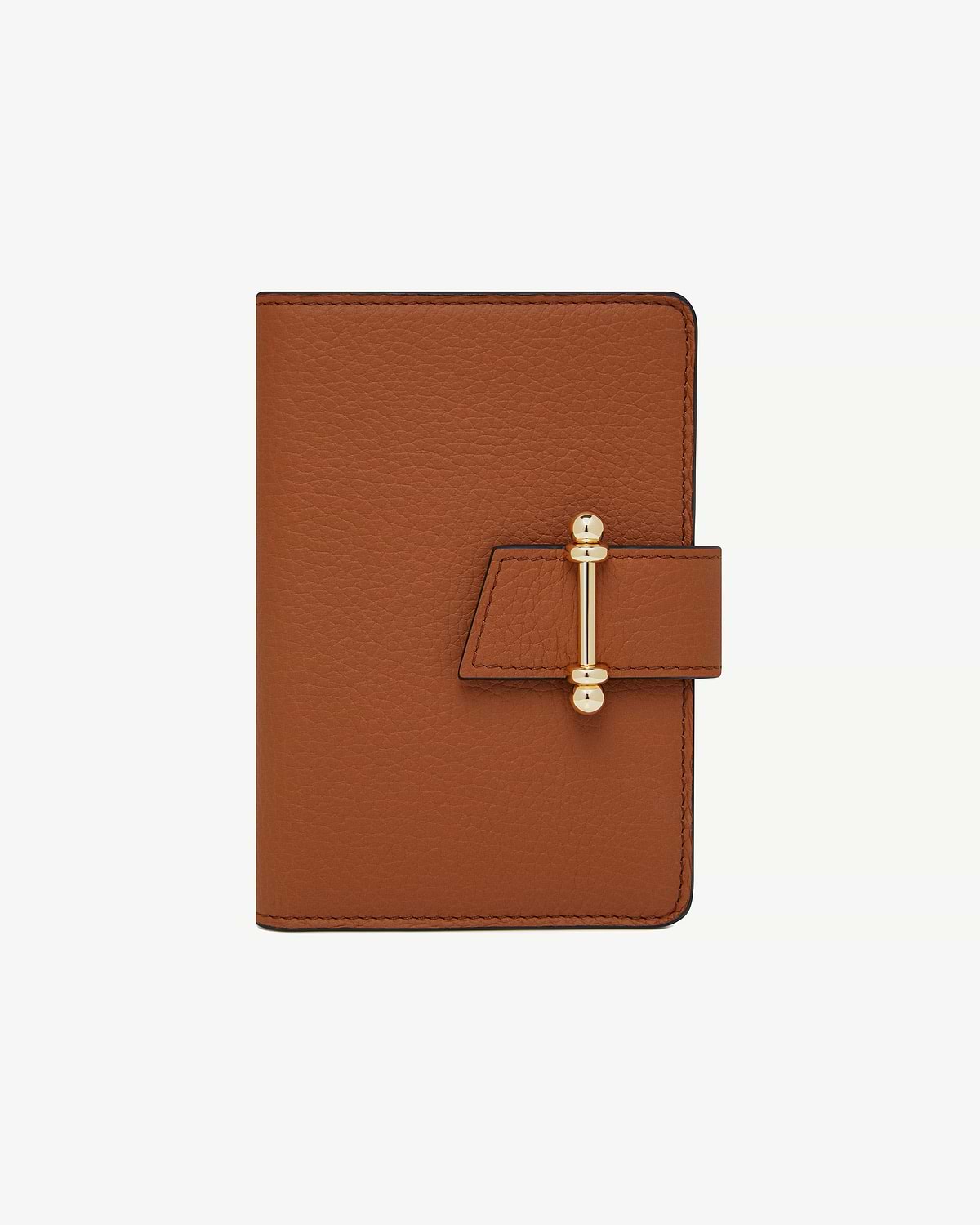 Tan leather passport holder with pebbled texture and gold bar clasp.