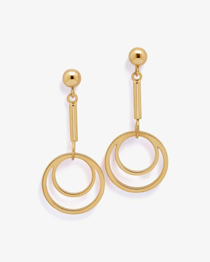 Pair of 22-carat gold gilded circle drop earrings with concentric rings on white background