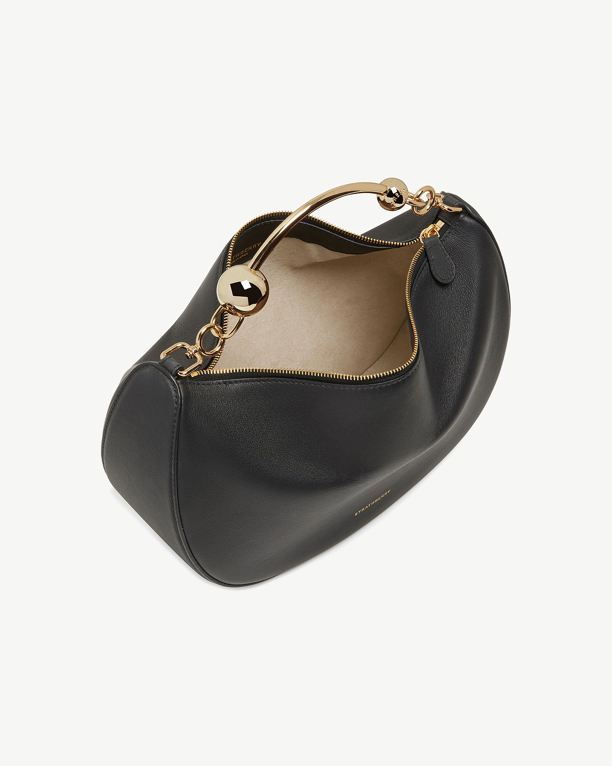 Strathberry black crescent moon leather bag with gold metal handle and beige lining.