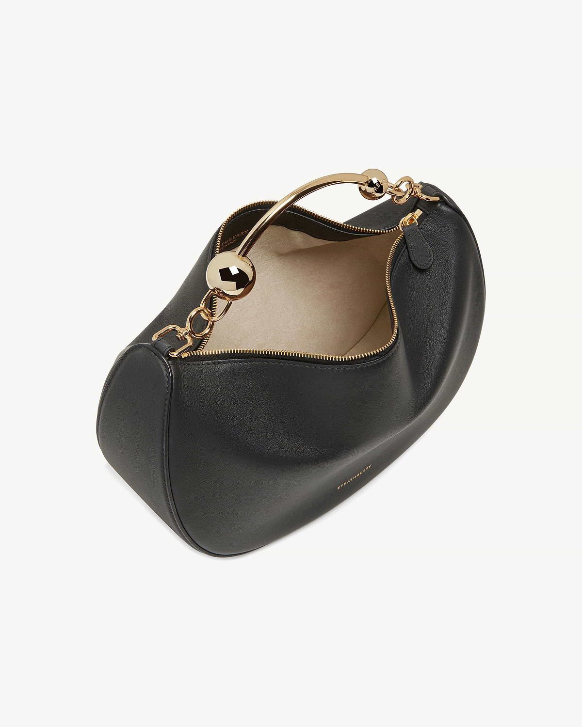 Strathberry black crescent moon leather bag with gold metal handle and beige lining.
