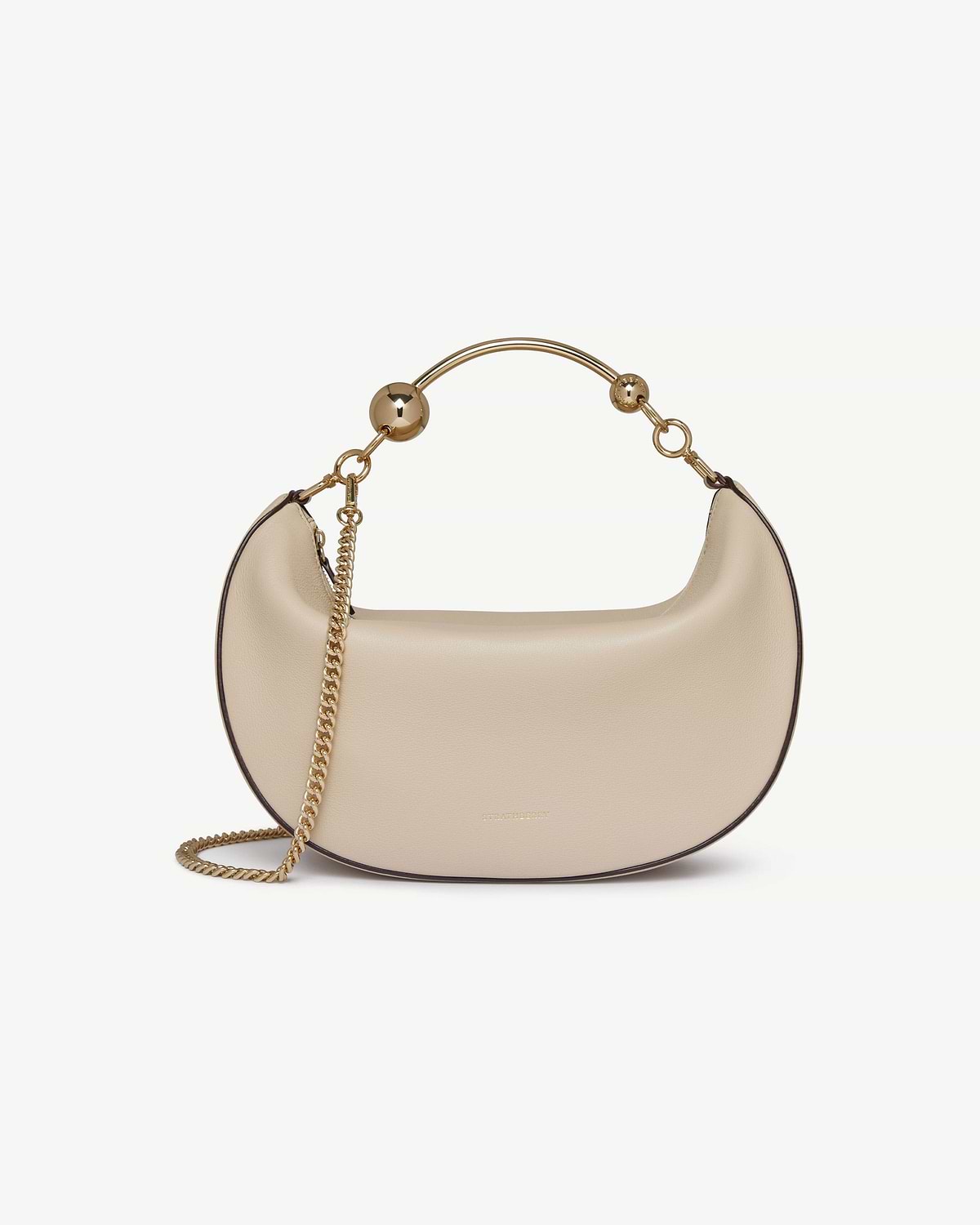 Oat crescent moon shoulder bag with gold metal handle and chain strap.