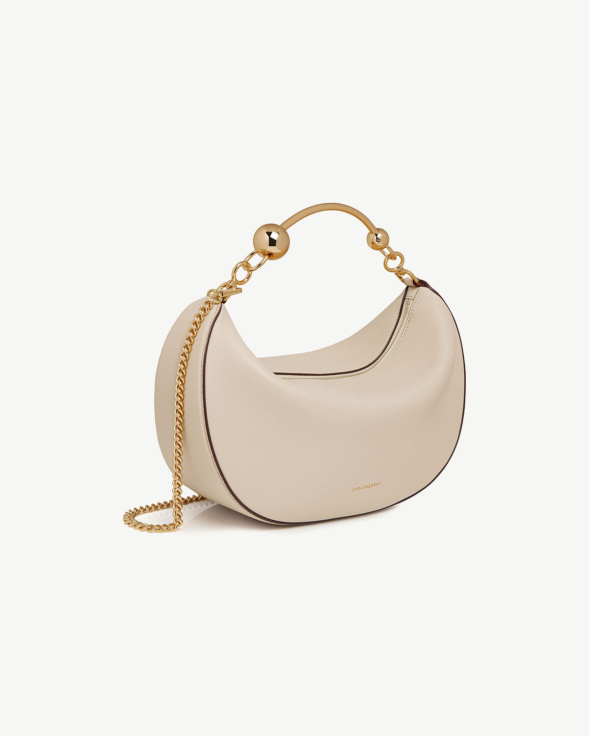 Strathberry Crescent Moon bag in oat with gold chain and ball handle.