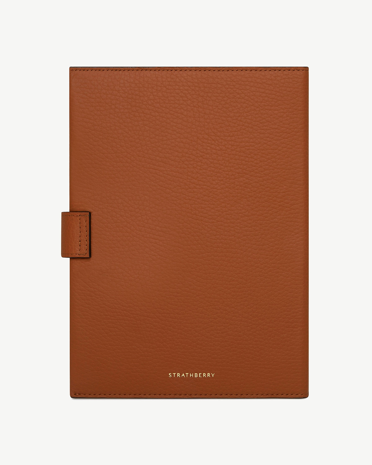 Tan leather Multrees notebook with Strathberry logo centred at bottom.