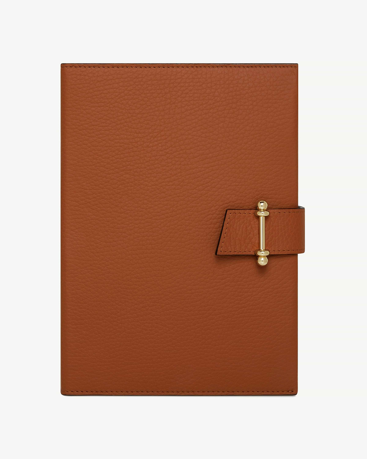 Tan leather notebook with pebbled texture and gold bar clasp.