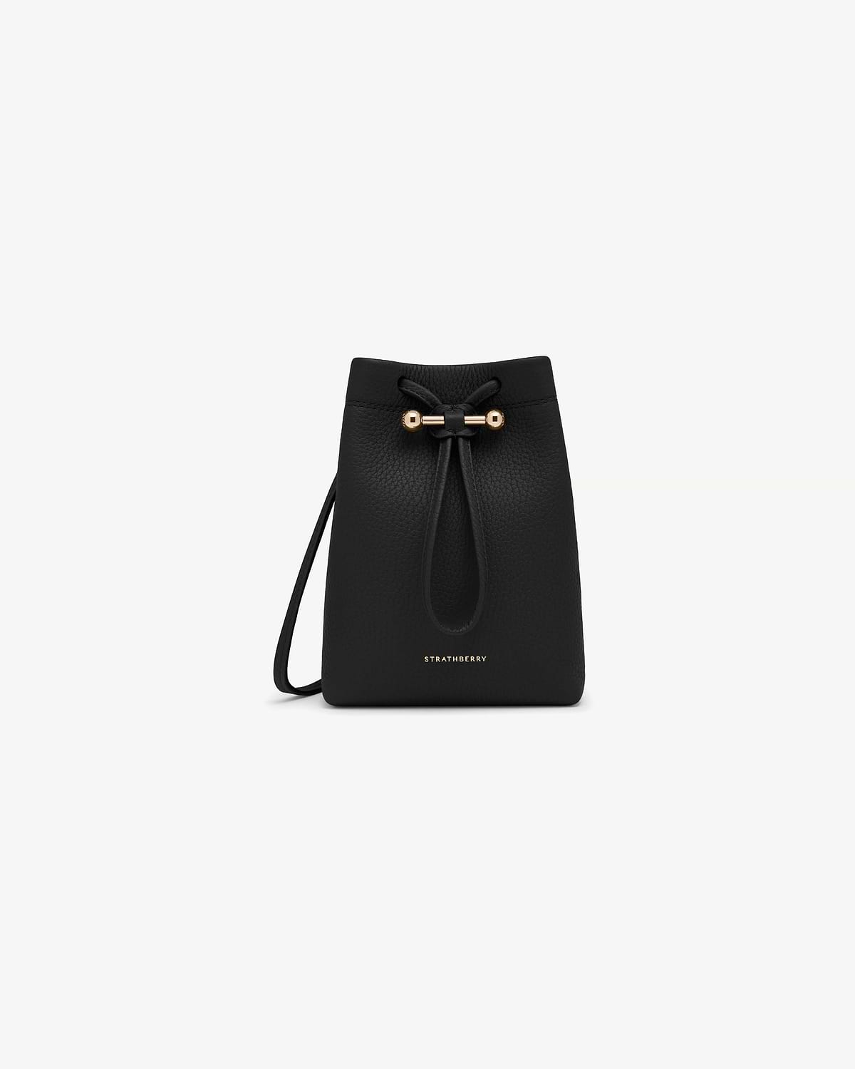 Black Strathberry Osette midi pouch in pebbled leather with drawstring and gold bar.