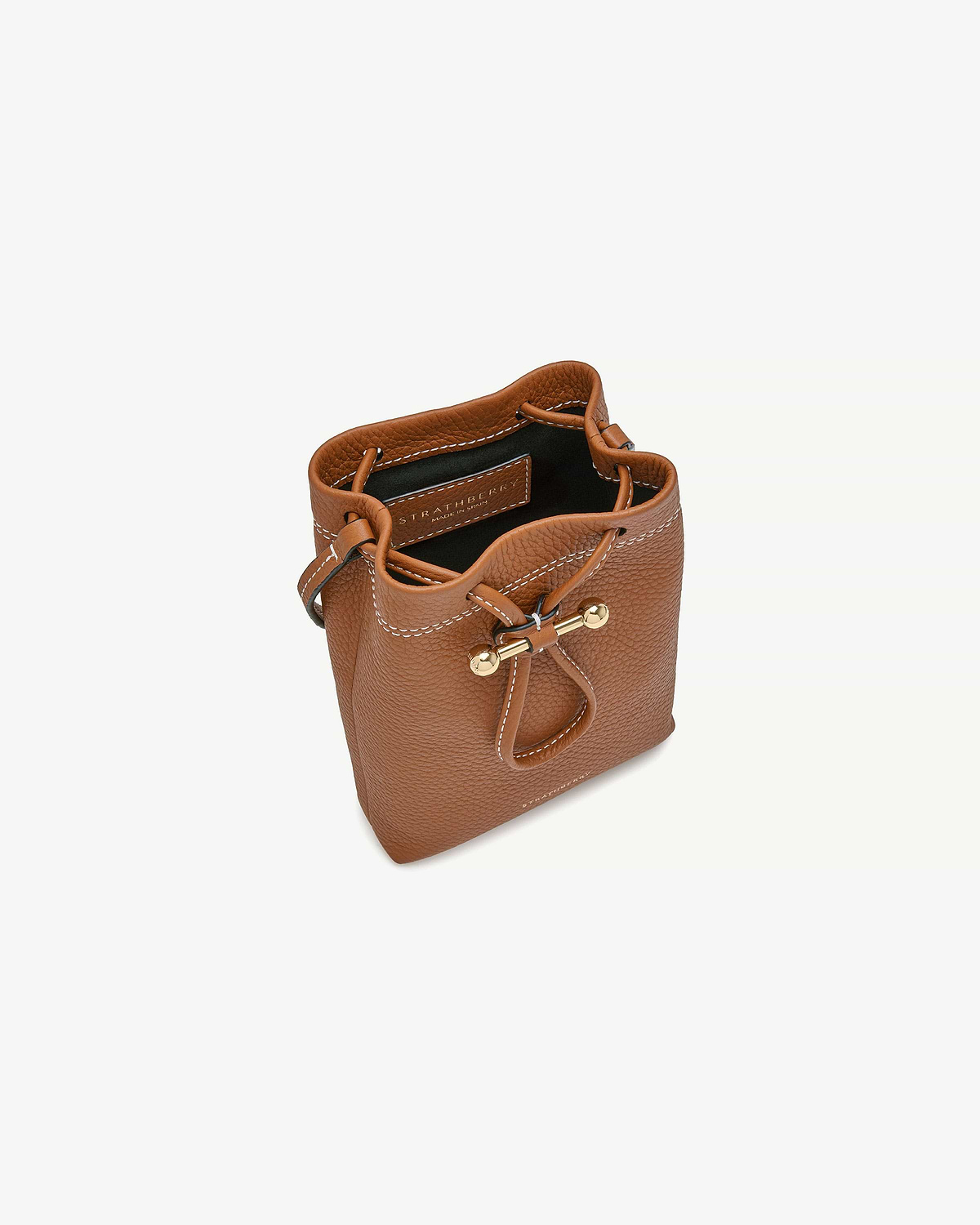 Tan Strathberry Osette midi pouch top view showing drawstring and gold fittings.