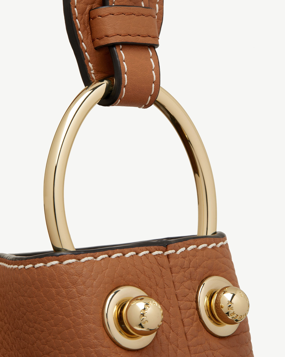 Tan leather strap with gold ring, stitched edge and gold stud detail.