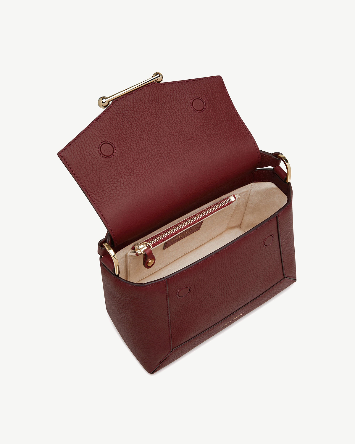 Oxblood leather mosaic bag open showing beige suede interior and gold hardware.