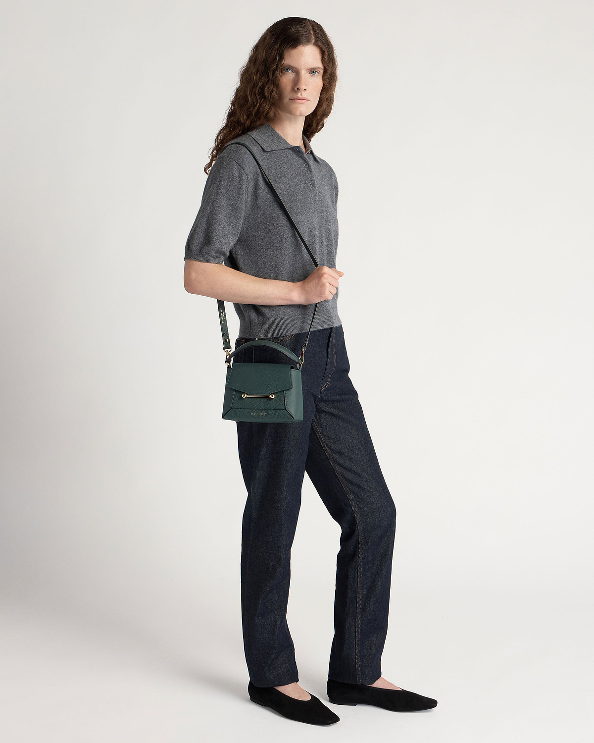 Model wearing grey top and jeans with bottle green Mosaic Nano crossbody bag.