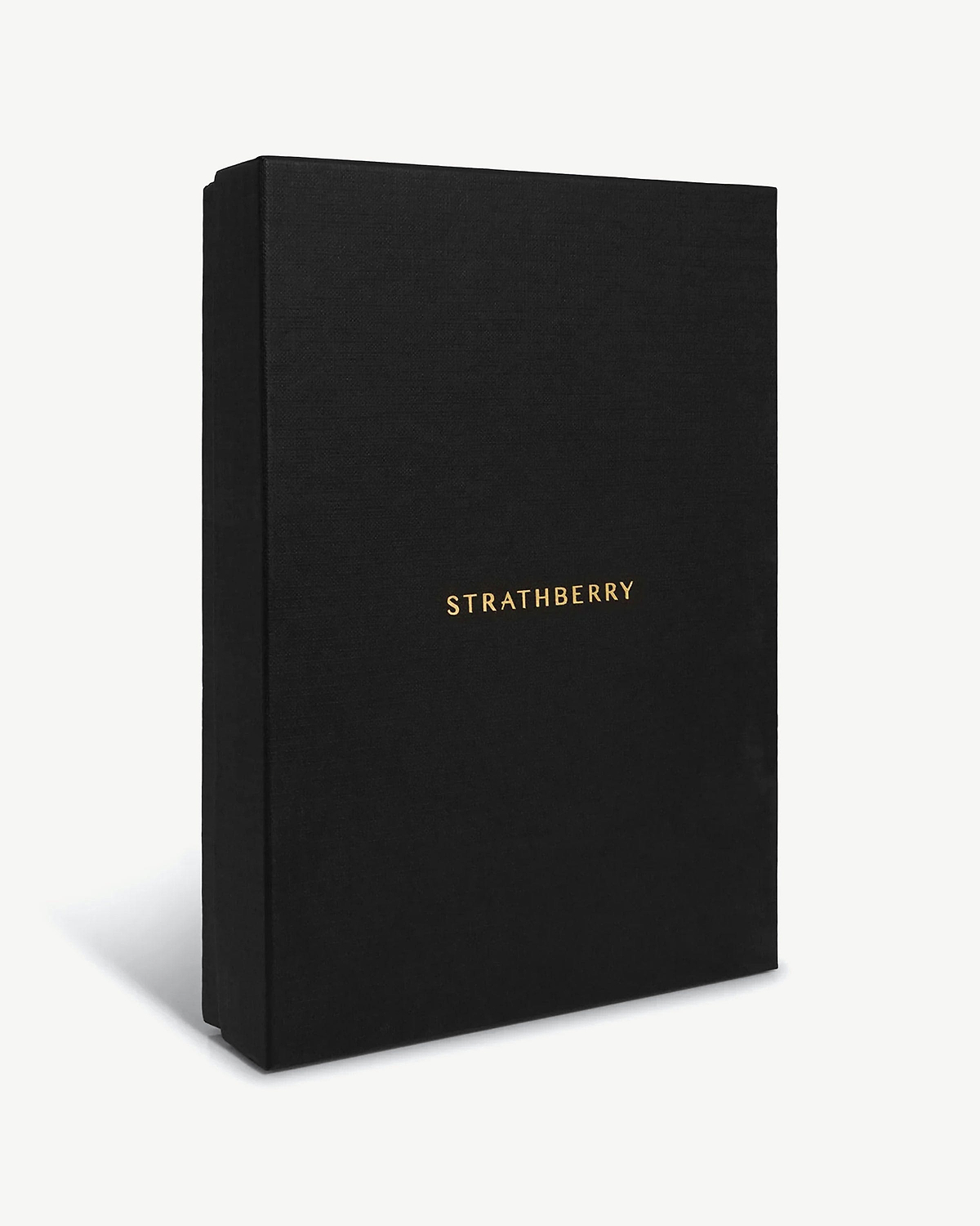 Black Multrees notebook with gold Strathberry logo on cover, standing upright on white background.