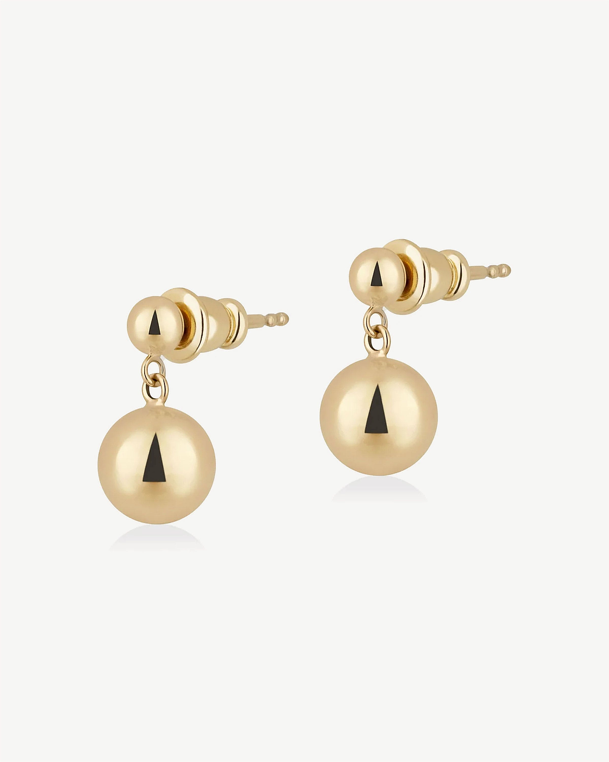 Pair of gold drop stud earrings with black triangular inlay on spherical drops