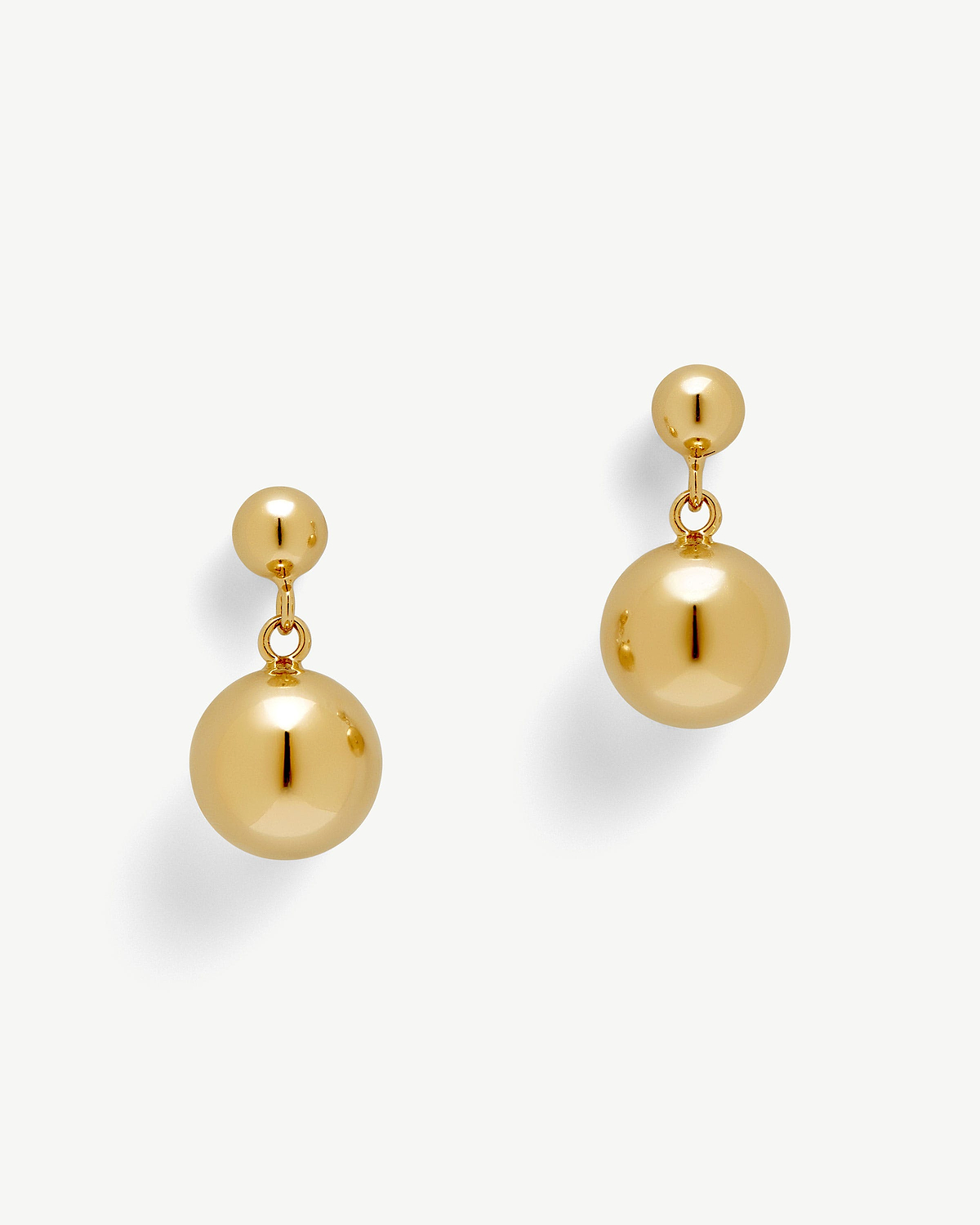 Pair of 22 carat gold gilded drop earrings with polished spherical beads.