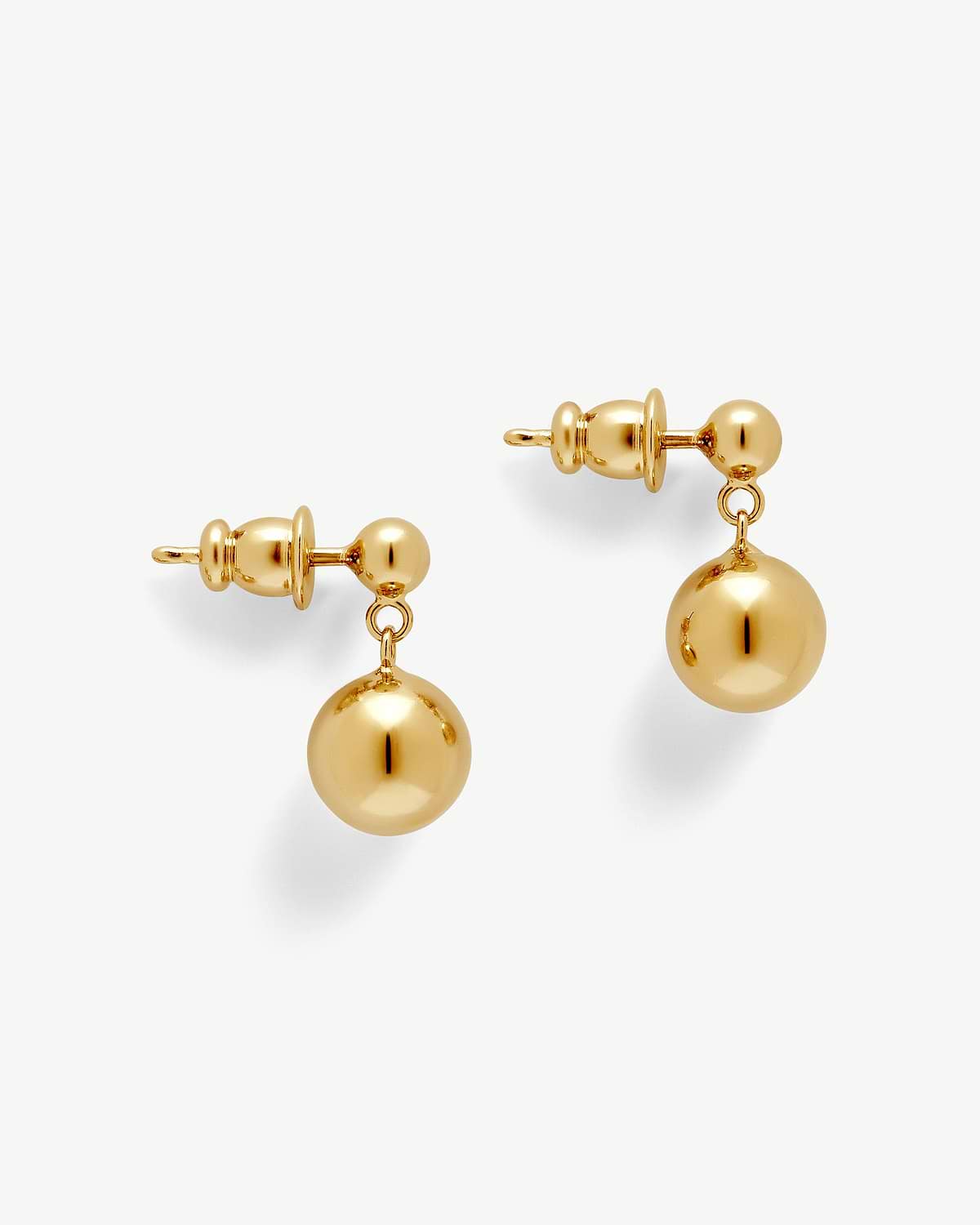 Pair of 22‑carat gold‑gilded drop earrings with polished spherical pendants
