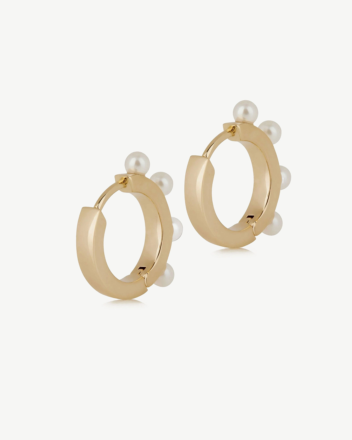 22 carat gold-gilded pearl huggie hoop earrings, pair on white background