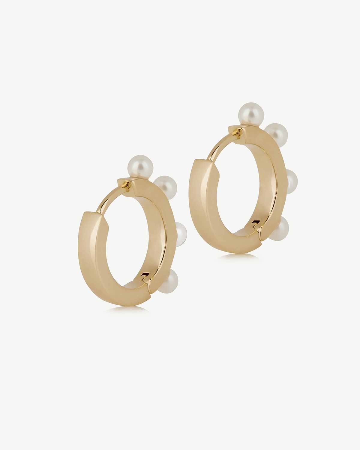 22 carat gold-gilded pearl huggie hoop earrings, pair on white background